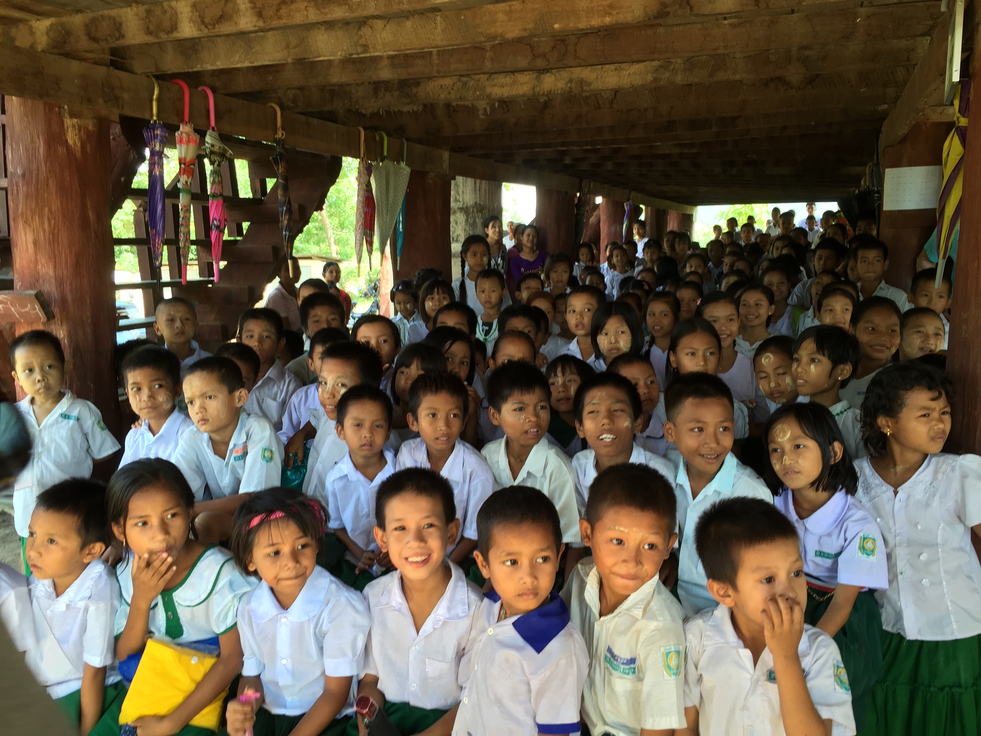 School children in Myanmar uniforms, smiling together